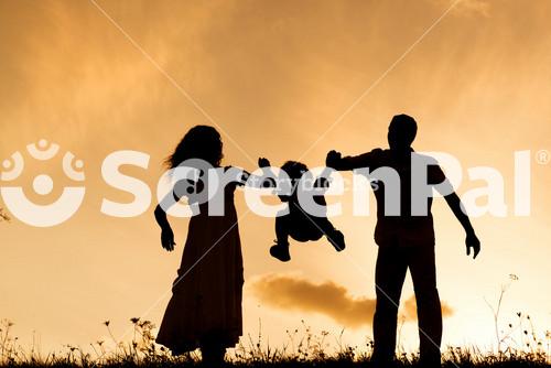 Silhouettes Of Happy Parents Having Fun With Their Children